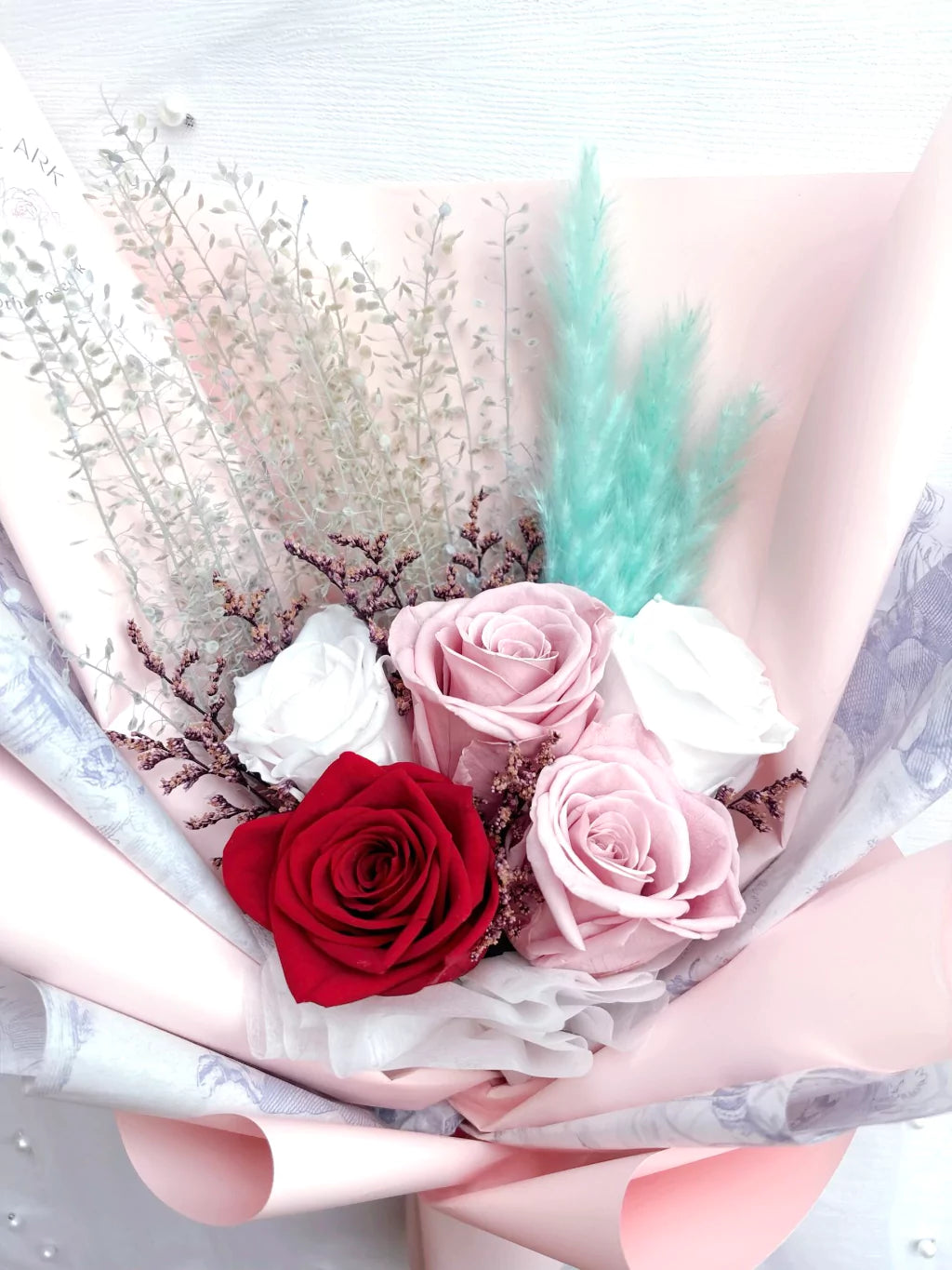 Red and pink preserved rose bouquet with dried fillers